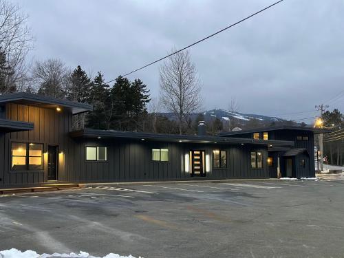 a building with a parking lot in front of it at Chalet 239-Boutique Hotel in West Dover