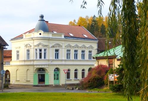 a large white building with a red roof at Vila Antik in Nové Hrady