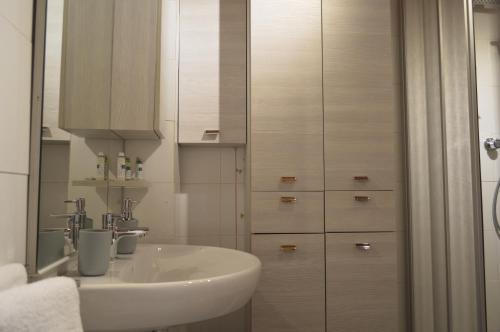 a white bathroom with a sink and a shower at Maison Chez Les Roset in Arvier