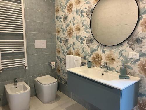 a bathroom with a sink and a toilet and a mirror at Il viandante in Sulmona
