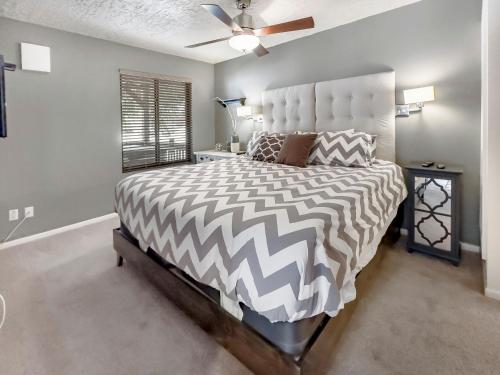 ein Schlafzimmer mit einem großen Bett mit einer schwarzen und weißen Bettdecke in der Unterkunft Hidden Creek Pond Perfection in Park City