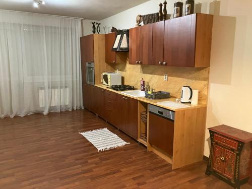 a kitchen with wooden cabinets and a counter top at Kosice ubytovanie v rodinnom dome in Košice