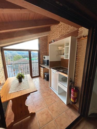 a kitchen with an open refrigerator and a table at Tranquilo apartamento vistas al Mondalindo 