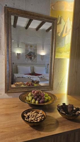 two plates of food on a table in front of a mirror at CAPPADOCIA MİHRAN SULTAN in Avanos