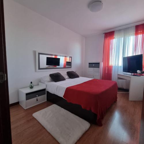 a bedroom with a bed and a flat screen tv at Habitación confort 