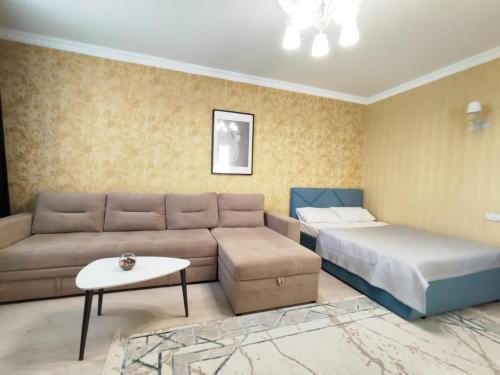 a living room with a couch and a bed at 102 2х комн кв с 2мя кроватями и 2мя диванами на 23м этаже с шикарным видом, возле Байтерека, кондиционер, фильтр для воды in Astana