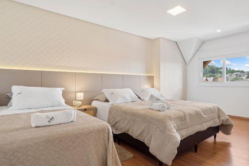 Postel nebo postele na pokoji v ubytování Solar da Garibaldi 3 Suítes by Achei Gramado