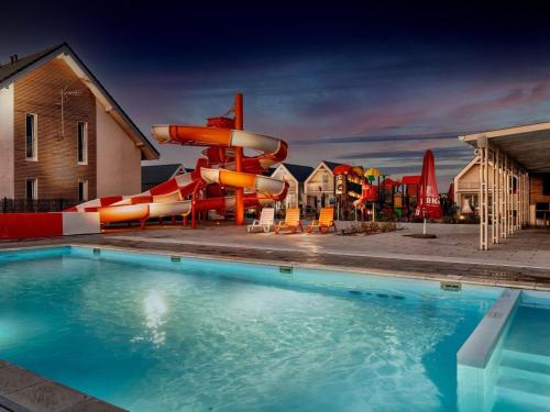 a pool with a slide and a water park at Comfortable apartments, swimming pool, Sarbinowo in Sarbinowo