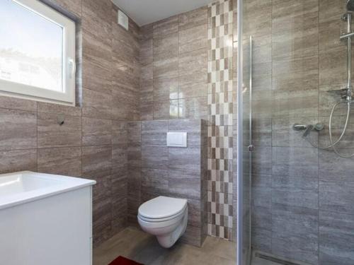 a bathroom with a toilet and a shower and a sink at Holiday homes close to the beach, Pobierowo in Pobierowo