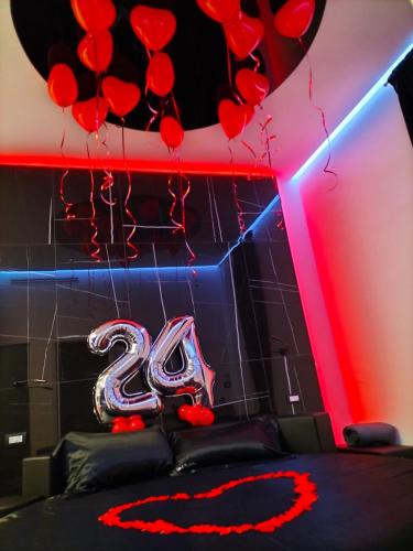a room with red hearts and a number on the wall at 50m2 Suite in Capurso