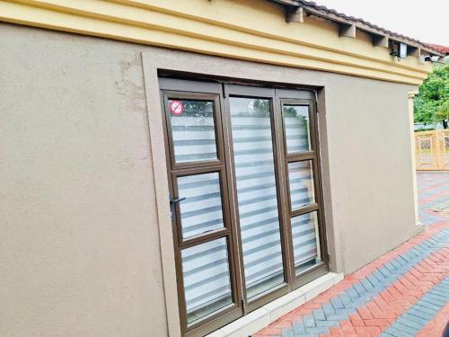 a door with a window on the side of a building at The Rose @ C-rane Lodge in Phalaborwa