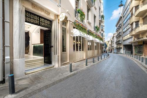 an empty street in a city with buildings at Belle Epoque Suites in Athens