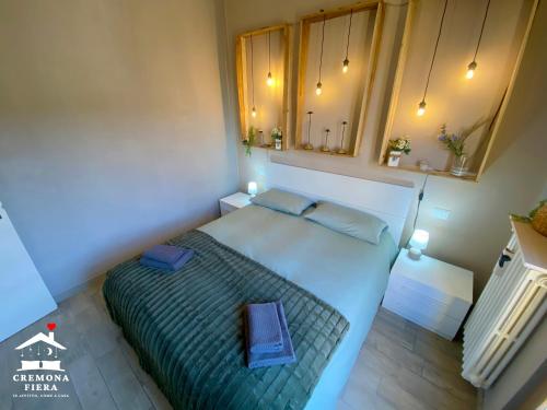 a bedroom with a large bed with blue pillows at APPARTAMENTO CREMONA FIERA in Cremona
