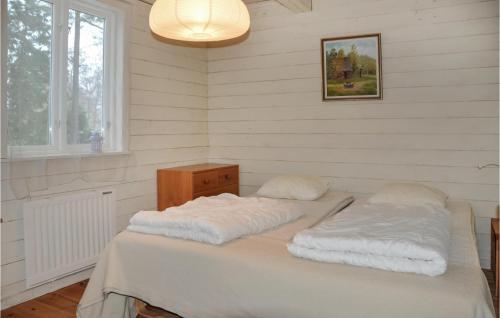 a bed with two pillows on it in a room at 2 Bedroom Cozy Home In Klssbol in Klässbol