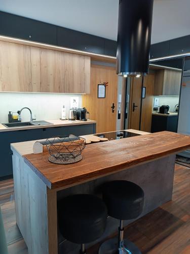 a kitchen with a wooden counter top in a room at Apartament Madlen Kalinowa Szczyrk Sauna Grota Solna in Szczyrk