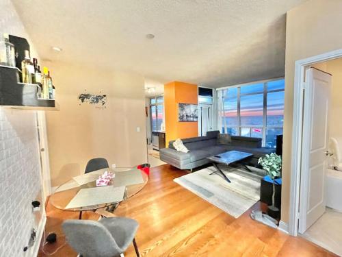 a living room with a couch and a table at Magnificent 2bed 2bath Condo in Mississauga