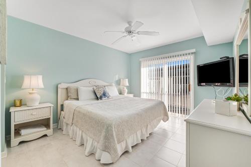 a bedroom with a bed and a flat screen tv at Surf Watch 104 in Ocean City