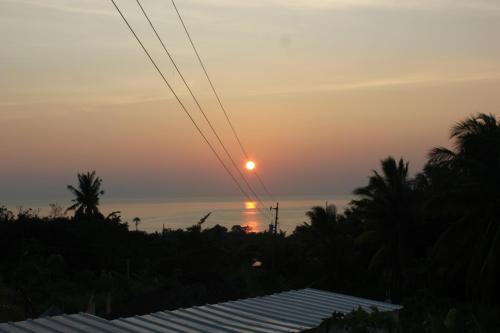a sunset over the ocean from a resort at Kalipay Bungalows Alcoy in Alcoy