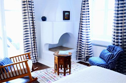 a living room with two chairs and a table at VILLA NAUTILIA - Luxury Suites and Cottages in Kalafatis