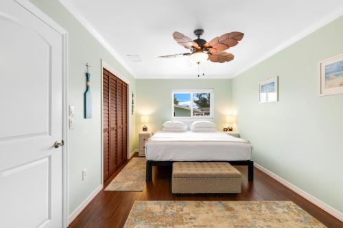 a bedroom with a bed and a ceiling fan at Minutes to Manasota Beach 2 King Beds Fenced yard Pets Welcome in Englewood