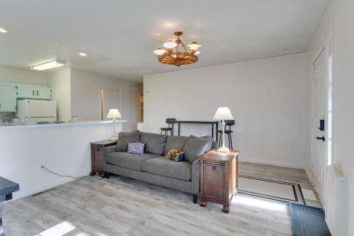 a living room with a couch and a kitchen at Convenient Colorado Horse Farm Apt with Balcony! in Aurora