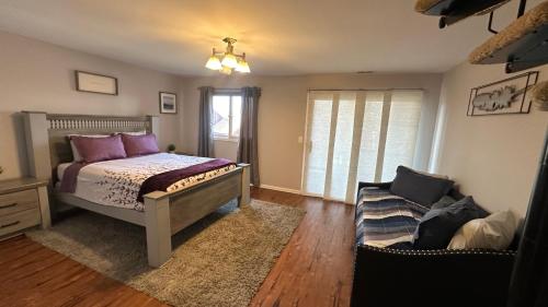 a bedroom with a bed and a couch at Ski on Ski off Mtn Chalet in Vernon