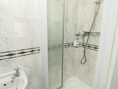 a bathroom with a shower with a glass door at Mountbatten House in Plymouth