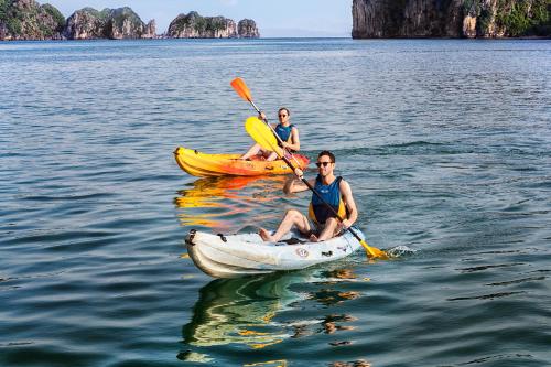two men in kayaks on the water in the ocean at Emeraude Classic Cruises in Ha Long