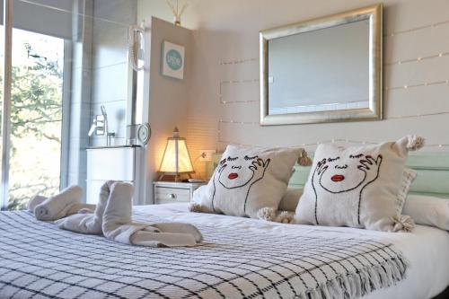 a bedroom with a bed with three polar bears pillows at Les Suites in Santa María de Palautordera