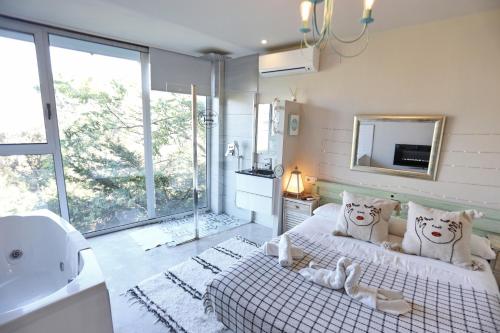 a bedroom with a bed and a sink and a mirror at Les Suites in Santa María de Palautordera