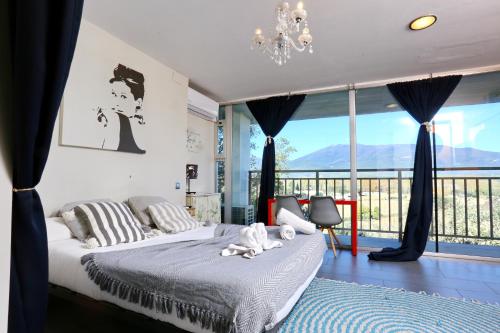 a bedroom with a bed and a large window at Les Suites in Santa María de Palautordera