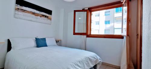 Schlafzimmer mit einem Bett und einem Fenster in der Unterkunft La Pla House in El Campello
