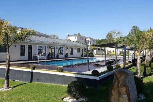 a house with a swimming pool in a yard at La Casa De Made-Luxury Apartment-No loadshedding in Sandton
