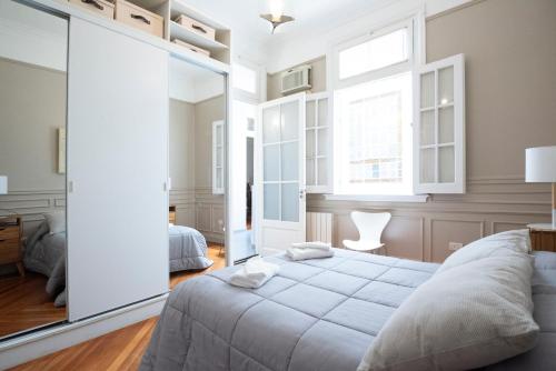 1 dormitorio con cama y espejo grande en Acogedor apartamento en Palermo Buenos Aires en Buenos Aires