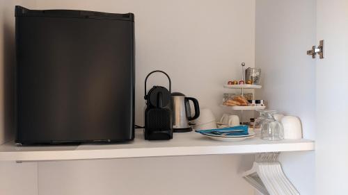 a television sitting on a shelf in a kitchen at B&B Casa Ninni in Camogli
