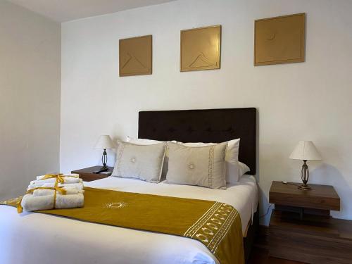 a bedroom with a large bed with a yellow blanket at Katari at Plaza de Armas Cusco in Cusco