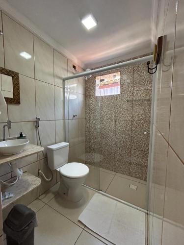 a bathroom with a toilet and a sink and a shower at Casa Eliane in Paraty