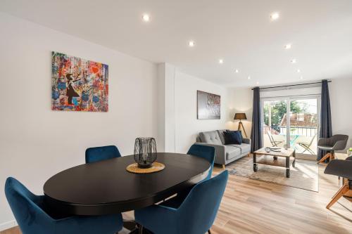 a living room with a dining room table and chairs at Private Apartment - Family - Palais des Festival - Parking - Cannes in Cannes