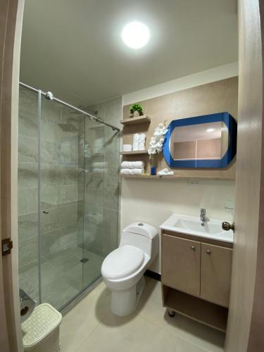 a bathroom with a shower and a toilet and a sink at Hotel Boutique Paralela Real. in Manizales