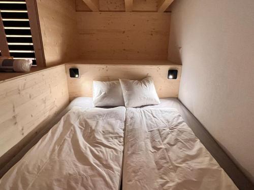 a bed in a small room with two pillows on it at studio suite im fresh-cube 