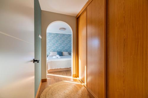 a bedroom with a bed and a hallway with a mirror at Villa Montalvo Beach in Montalvo