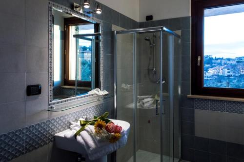 a bathroom with a shower and a sink and a mirror at Bed and Breakfast Ocarè in San Gemini