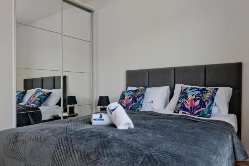 a bed with a pair of towels on top of it at Apartamenty Belni Hel Edyta i Maciej Wolak in Hel