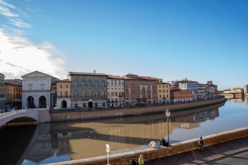 a city with a bridge over a river with buildings at Anna Teresa Luxury in Pisa