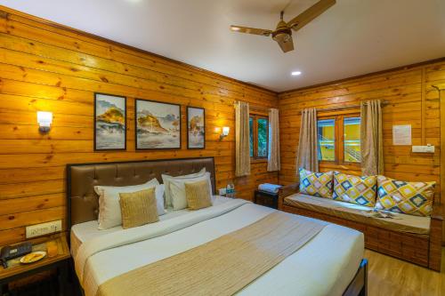 a bedroom with a bed and a bench in it at La Cabana Beach & Spa, By Ashvem Beach in Mandrem