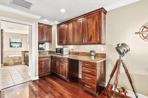 a kitchen with wooden cabinets and a camera at Florida Space Coast Waterfront Retreat in Cocoa