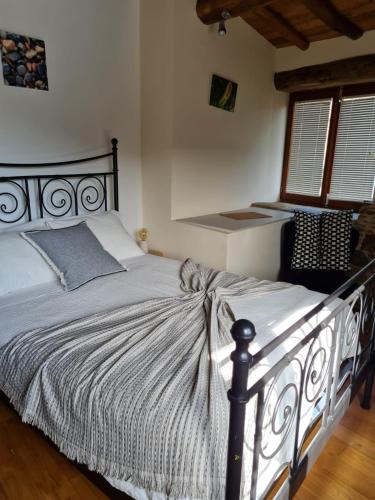 a bedroom with a bed in a room with a window at Cabo Do Mundo Casa Rural in Chantada