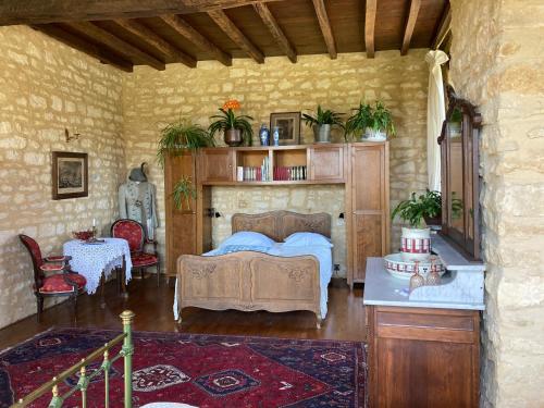 a bedroom with a bed and a table with plants at Maison Les Beaux Arts in Mouzay