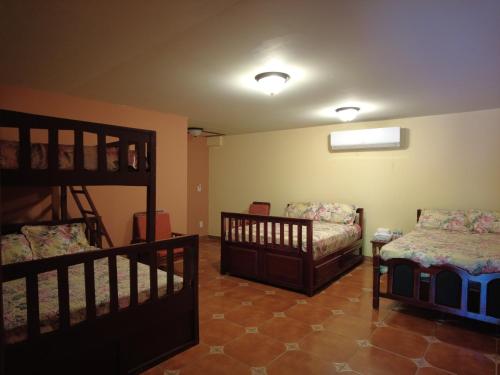 a room with two cribs and a bunk bed at El Castillo de Piedra in San Miguel
