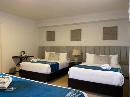 a hotel room with two beds in a room at Katari at Plaza de Armas Cusco in Cusco